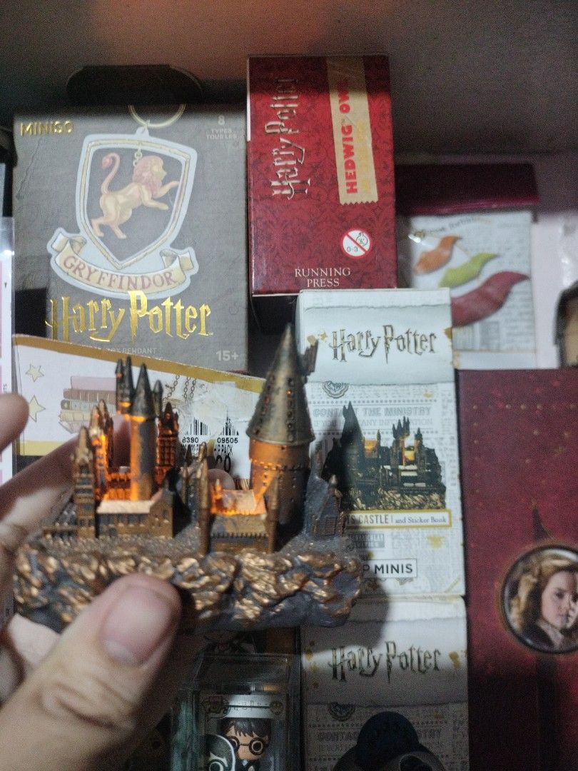 Harry Potter Hogwarts Castle Mini Figurine with Light (Category: Figurines & Statues) located in Paranaque City. Submitted by chechein_shop (Listing ID 1470967334, Image 1). Description: - Official-style miniature Hogwarts castle replica from Harry Potter - Features built-in glowing lights inside the towers for a magical effect - Detailed textured rocky base for realistic display - Compact size, ideal for desk or shelf decoration - Perfect collec