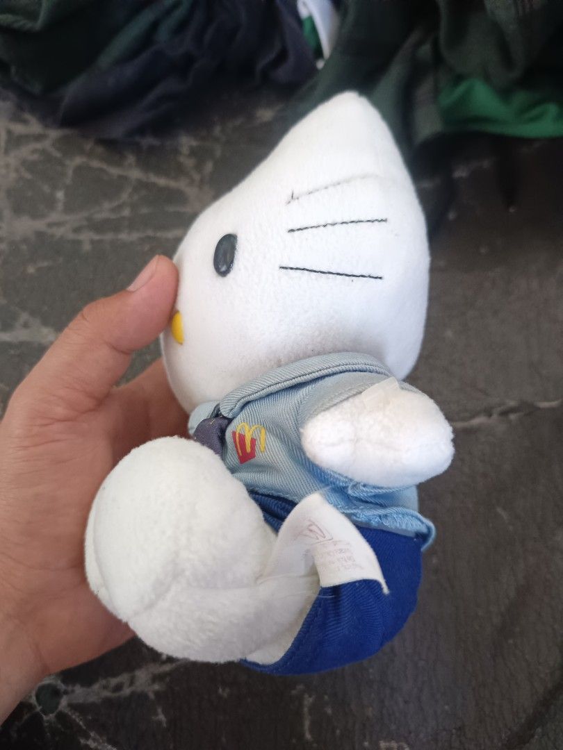 Hello Kitty McDonald's Daniel Uniform Plush Toy (Category: Plushies & Soft Toys) located in Caloocan City. Submitted by just_thrift_thing (Listing ID 1471018218, Image 3). Description: - Character: Kitty dressed in an exclusive McDonald's worker uniform - Outfit: Blue shirt, dark blue cap with McDonald's logo, patterned tie, and 'Daniel' name tag - Features: Classic white plush body, black whiskers, and iconic yellow nose - Condition: Good overal