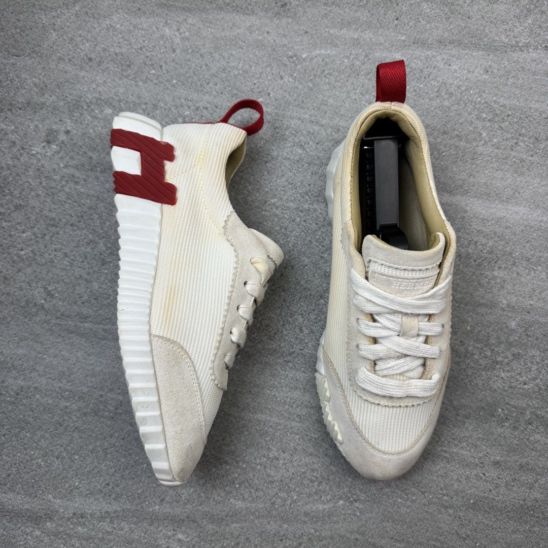 Hermes White and Red Sneakers (Category: Sneakers) located in Manolo Fortich. Submitted by thrift_by_biji (Listing ID 1471089688, Image 2). Description: - Brand: Hermes - Color: Cream white with red heel tab - Material: Premium suede and canvas combination - Design: Distinctive H logo on the outsole, lace-up closure with tongue branding - Sole: Chunky white ridged sole for extra grip and style - Condition: Pre-owned with noticeable yellowing stai