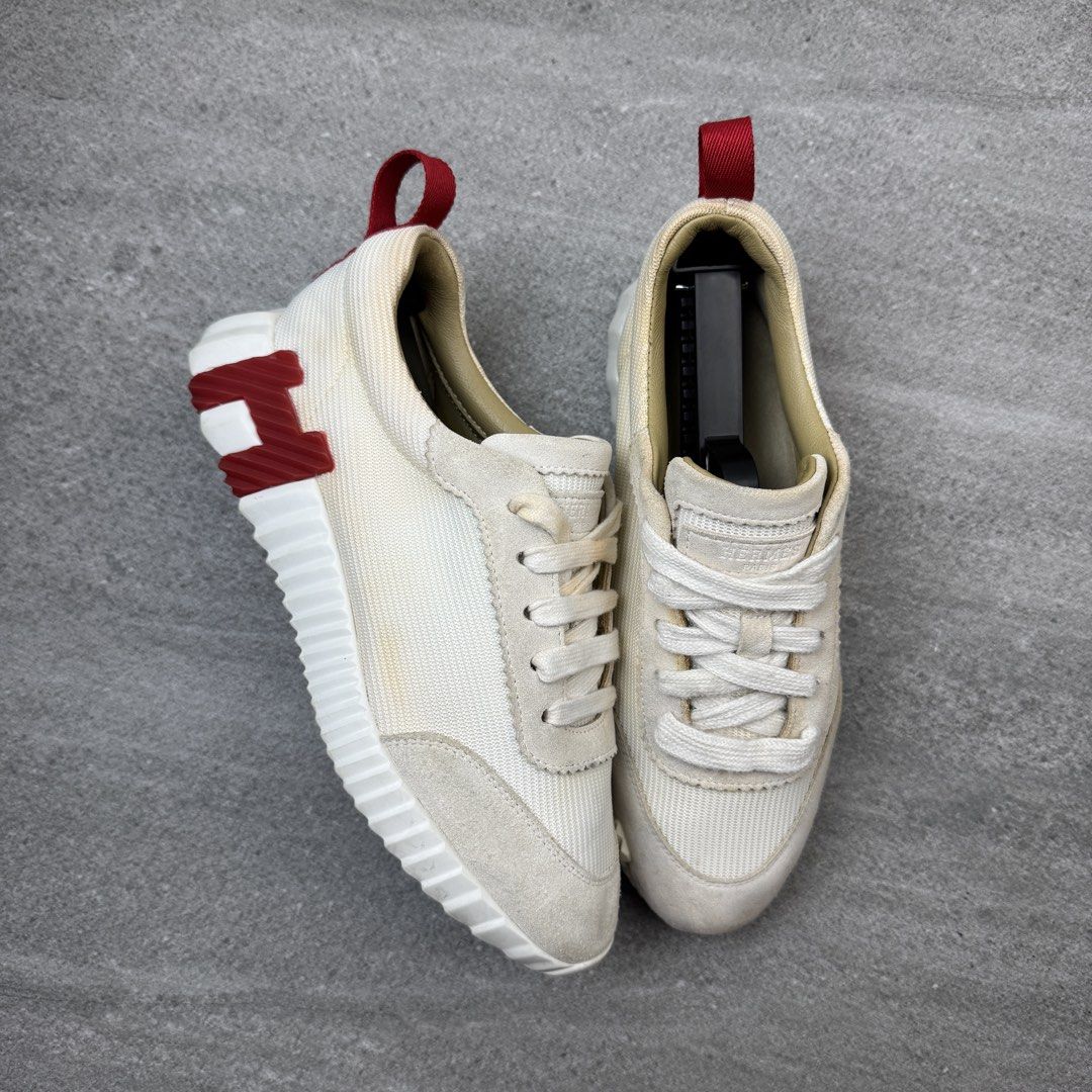 Hermes White and Red Sneakers (Category: Sneakers) located in Manolo Fortich. Submitted by thrift_by_biji (Listing ID 1471089688, Image 1). Description: - Brand: Hermes - Color: Cream white with red heel tab - Material: Premium suede and canvas combination - Design: Distinctive H logo on the outsole, lace-up closure with tongue branding - Sole: Chunky white ridged sole for extra grip and style - Condition: Pre-owned with noticeable yellowing stai
