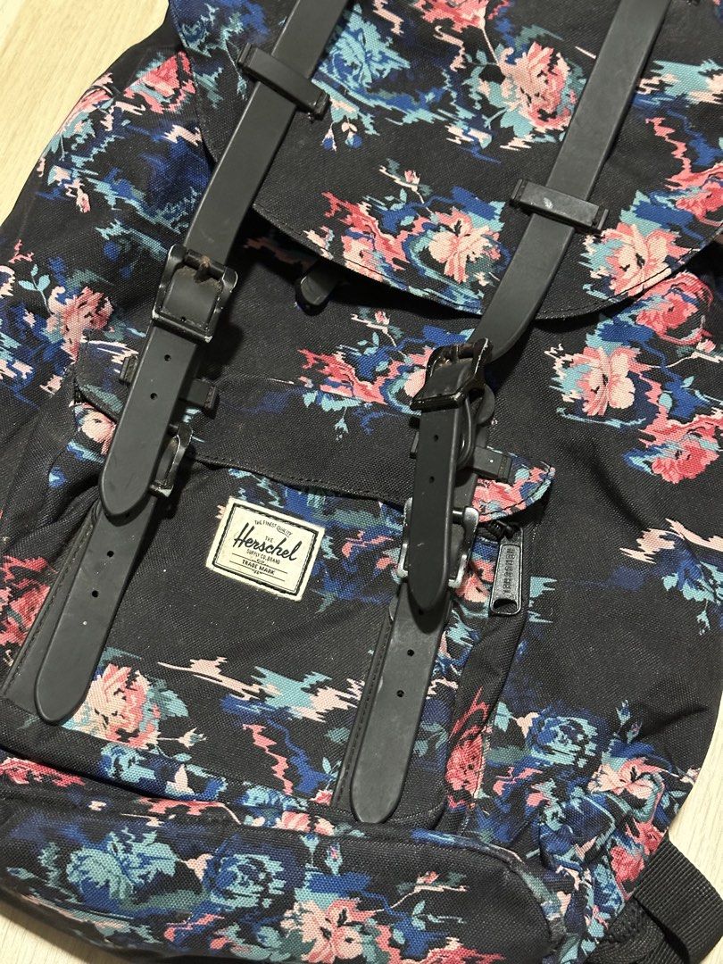 Herschel Supply Co. Floral Print Backpack (Category: Backpacks) located in Mandaluyong City. Submitted by supercleng (Listing ID 1471075965, Image 2). Description: - Brand: Herschel Supply Co. - Closure: Drawstring cinch top with magnetic buckle straps and adjustable metal hardware - Pockets: Convenient front zipped pocket with classic woven Herschel logo patch - Interior: Signature red and white striped fabric lining.