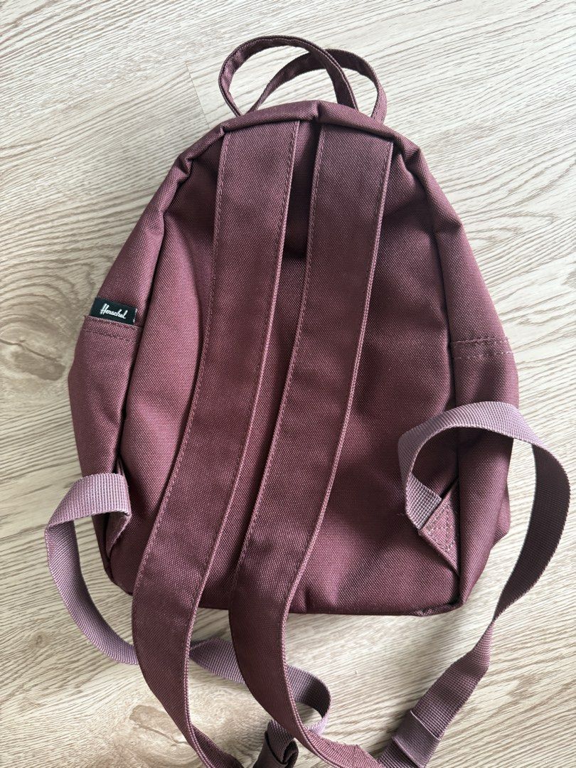Herschel Supply Co. Nova Mini Backpack Plum Purple (Category: Backpacks) located in Pasig City. Submitted by anjeg (Listing ID 1470953652, Image 2). Description: - Brand: Herschel Supply Co. - Style: Mini Backpack - Color: Plum Purple - Features: Signature red and white striped fabric lining, front zip pocket with gold-tone hardware, dual top carrying handles, and adjustable shoulder straps - Condition: Clean inside and out - Perfect for: Daily e