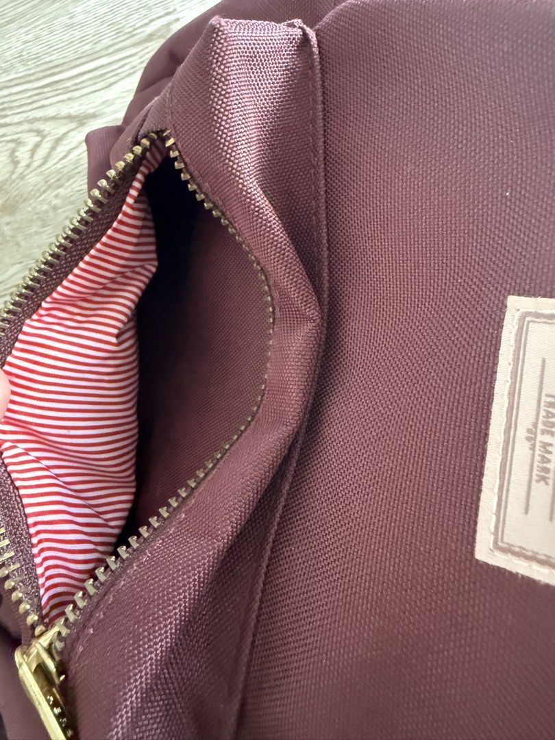 Herschel Supply Co. Nova Mini Backpack Plum Purple (Category: Backpacks) located in Pasig City. Submitted by anjeg (Listing ID 1470953652, Image 3). Description: - Brand: Herschel Supply Co. - Style: Mini Backpack - Color: Plum Purple - Features: Signature red and white striped fabric lining, front zip pocket with gold-tone hardware, dual top carrying handles, and adjustable shoulder straps - Condition: Clean inside and out - Perfect for: Daily e