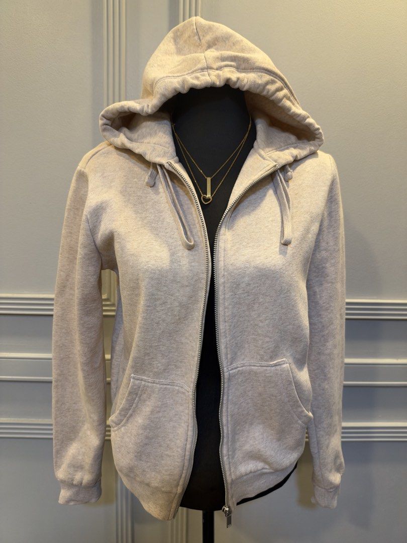 H&M Basics Beige Zip-up Hoodie Size S (Category: Coats, Jackets and Outerwear) located in Manila. Submitted by anjcuenca (Listing ID 1471097229, Image 2). Description: - Brand: H&M Basics - Style: Zip-up hoodie with full front zipper and adjustable drawstring hood - Color: Soft beige heather - Size: S (fits UK S) - Features: Two front pockets, cozy and soft fabric - Condition: Clean, excellent, and ready to wear.