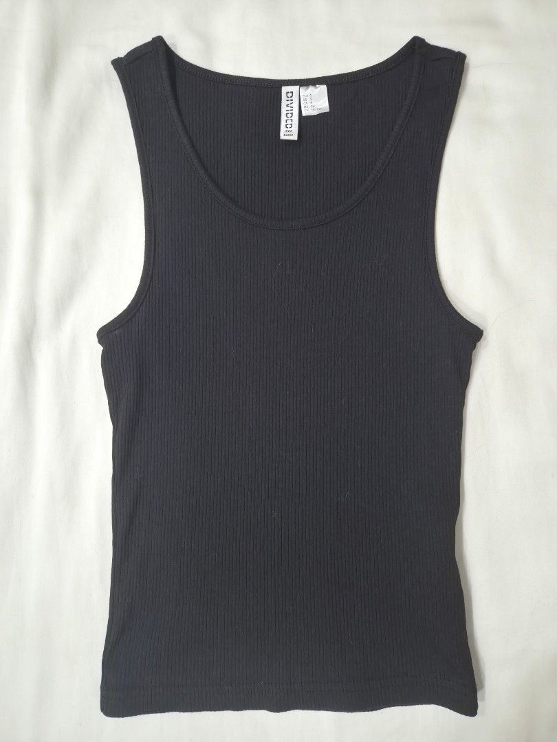 H&M Divided Black Ribbed Tank Top (Category: Sleeveless) located in Quezon City. Submitted by corrnic (Listing ID 1471116830, Image 3). Description: - Brand: H&M Divided - Color: Classic black - Material: Stretchy, comfortable cotton ribbed fabric - Fit: Fitted cut with scoop neckline on front and back - Style: Easy basic piece, perfect for layering or wearing on its own - Condition: Great wardrobe essential.