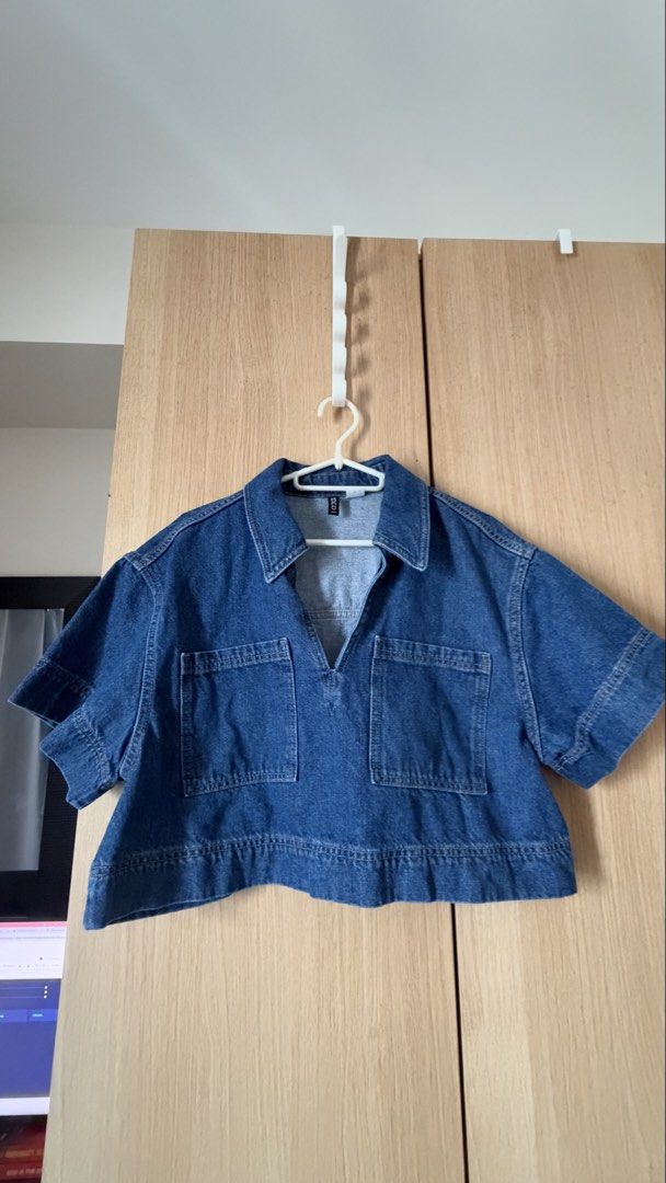 H&M divided denim crop top size M (Category: Shirts) located in Mandaluyong City. Submitted by andreyamari_ (Listing ID 1470983676, Image 1). Description: - Brand: H&M Divided - Item: Short-sleeve cropped denim shirt - Color/Wash: Medium blue - Details: Classic collar, front V-neck cut, two chest patch pockets, wide hem - Size: Medium (true to size) - Condition: Good, ready to wear.
