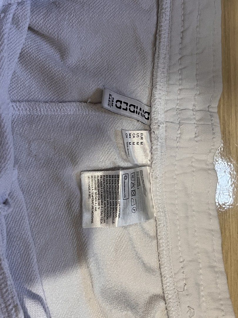 H&M Divided White Casual Shorts Size M (Category: Shorts) located in Pasig City. Submitted by vvaana (Listing ID 1470997085, Image 2). Description: - Brand/Line: H&M Divided - Size: For plus size - Material: 56% polyester, 44% cotton blend with soft French terry interior - Features: Elastic waistband with adjustable drawstring and two functional side pockets - Style: Clean, simple design ideal for lounging or running errands - Condition: Brand ne