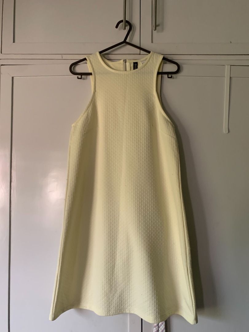 H&M DIVIDED Yellow Dress (Category: Dresses) located in Abucay. Submitted by charkolefishies (Listing ID 1470984536, Image 1). Description: - Brand: H&M Divided - Color: Bright Yellow - Style: Sleeveless, high neckline, A-line cut - Fabric: Textured pattern throughout - Closure: Back neck zipper - Length: Above the knee, 80cm / 31 in - Condition: Excellent, easy to dress up or down for warm weather.