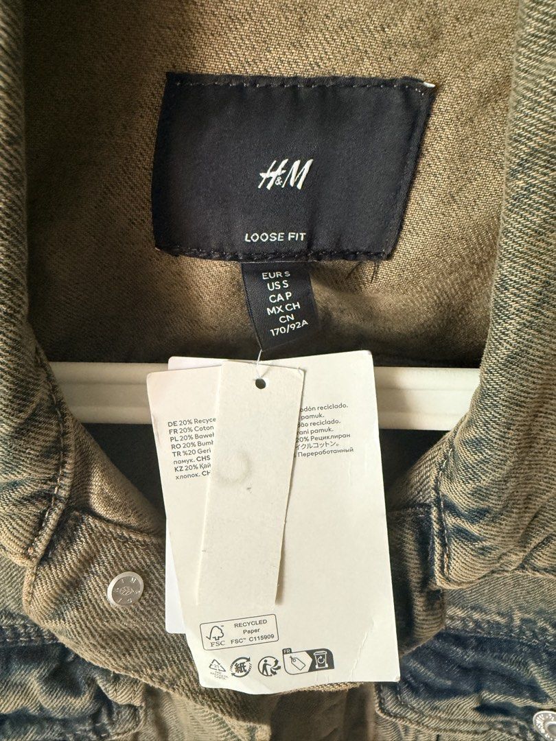 H&M Denim Jacket Brand New with Tag (Category: Coats, Jackets and Outerwear) located in Pasig City. Submitted by thetravellingguyinstyle (Listing ID 1470962175, Image 2). Description: - Brand: H&M - Item: Denim Jacket - Fit: Loose fit (great for layering) - Size: S - Condition: Brand new with tag attached - Features: Button-up front, chest pockets, and side pockets.
