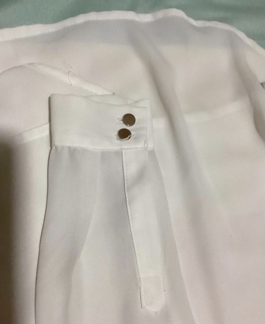 H&M White Button-Up Blouse with Pocket Details (Category: Blouses) located in Paranaque City. Submitted by calm_youngstore7 (Listing ID 1470989115, Image 3). Description: LAST PIECE SALE! - Brand: H&M - Condition: Brand new with original store tags attached - Color: Crisp white - Size: EUR 32, US 2, CA 2 - Material: Lightweight with a slight sheer look - Details: Classic collar, front button closure, button cuffs, and chest pockets with stylish s