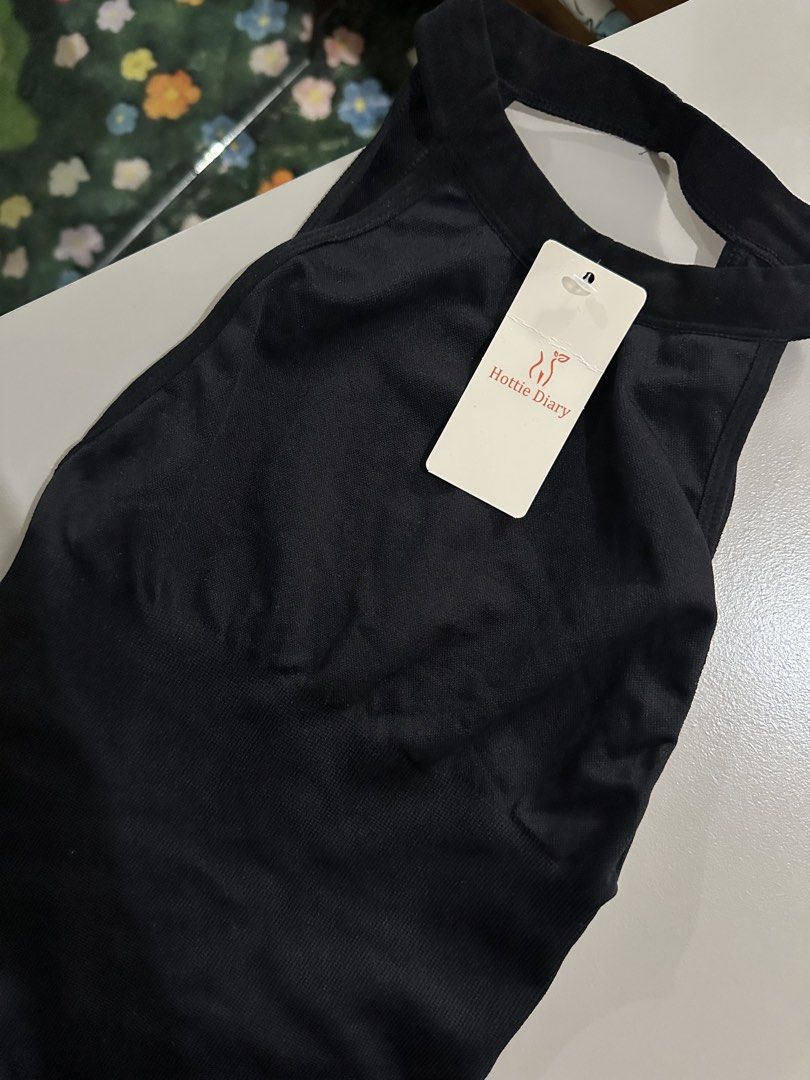 Hottie Diary Black Romper Size S (Category: Rompers) located in Antipolo. Submitted by wxyz9876 (Listing ID 1470962862, Image 2). Description: - Brand: Hottie Diary - Condition: Brand new with tag (BNWT) - Size: S - Color: Black - Material: 85% polyamide, 15% elastane - Design: Ribbed fabric, halter neckline, open back, and ruched back detail.