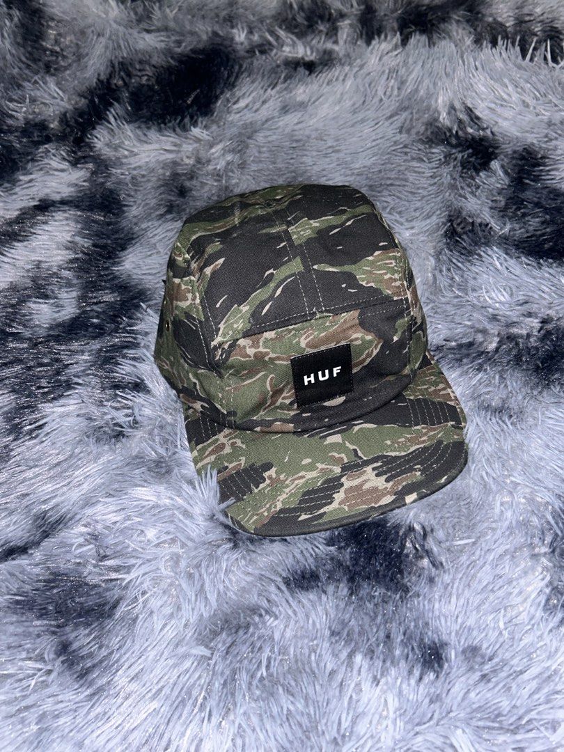 HUF Tiger Camo Volley 5 Panel Cap (Category: Caps & Hats) located in Cadiz. Submitted by jaybatiller (Listing ID 1471041394, Image 2). Description: - Brand: HUF - Style: 5-panel cap in olive tiger camo - Condition: Brand new, clean inside and out with interior tags attached - Material: 100% cotton - Features: Woven box logo patch on front, metal side eyelets, and adjustable black nylon strapback with plastic buckle.