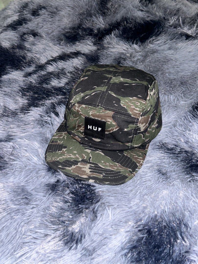 HUF Tiger Camo Volley 5 Panel Cap (Category: Caps & Hats) located in Cadiz. Submitted by jaybatiller (Listing ID 1471041394, Image 3). Description: - Brand: HUF - Style: 5-panel cap in olive tiger camo - Condition: Brand new, clean inside and out with interior tags attached - Material: 100% cotton - Features: Woven box logo patch on front, metal side eyelets, and adjustable black nylon strapback with plastic buckle.