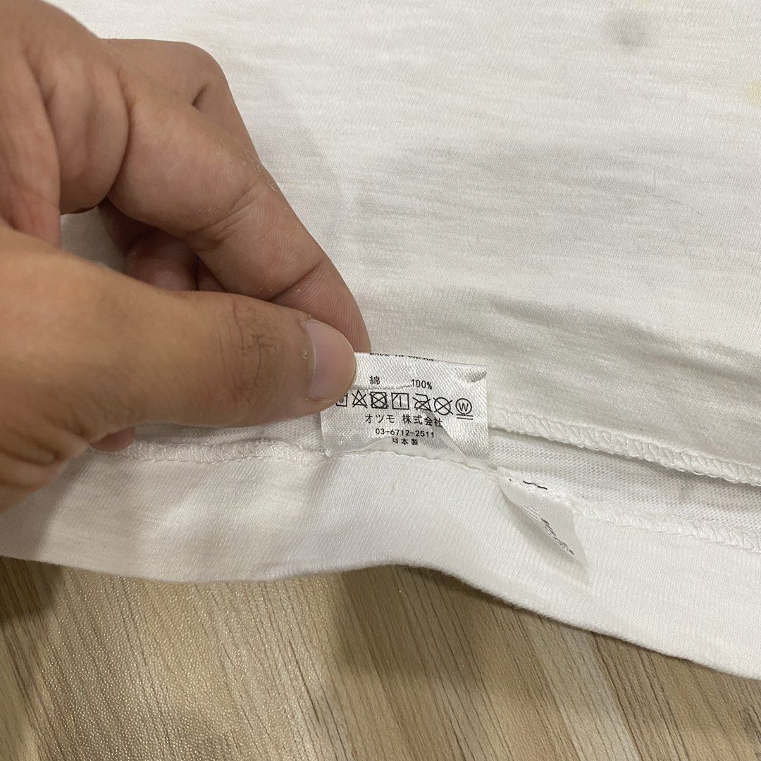 Human Made Panda White Graphic T-Shirt (Category: Shirts) located in Manila. Submitted by scapethrift (Listing ID 1470973911, Image 3). Description: - Brand: Human Made - Item: White graphic tee with panda eating bamboo and 'STRMCWBY HUMAN made' lettering - Size: Large - Material: 100% cotton, made in Japan - Condition: Comes with inner care tags and neck label; note a few faint yellow stains near the bottom front area.