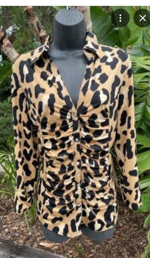 INC International Concepts Leopard Print Ruffled Button Blouse (Category: Blouses) located in Manila. Submitted by duffy-080 (Listing ID 1470988772, Image 2). Description: - Brand: INC International Concepts - Pattern: Bold tan and black leopard print - Design: Chic ruched front with decorative center buttons and a classic collared neckline - Sleeves: Three-quarter length with trendy folded cuffs - Fabric: Lightweight and comfortable - Versatilit