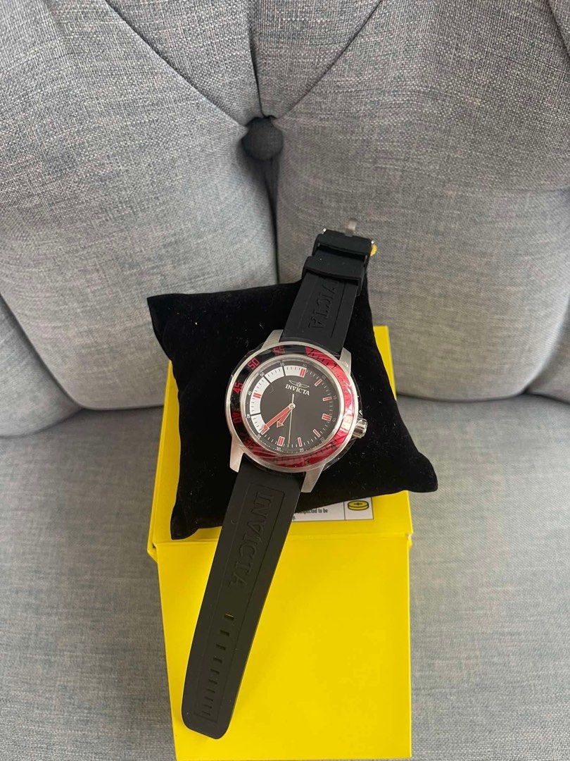Invicta Black and Red Watch with Original Box (Category: Women's Watches) located in Caloocan City. Submitted by Roowchelly (Listing ID 1470932936, Image 1). Description: - Brand: Invicta - Condition: Unworn, stored properly in box - Dial: Black with bold red accents and bezel ring - Strap: Black rubber with embossed logo lettering - Hardware: Silver-tone case and crown - Style: Sporty and eye-catching - Inclusions: Original bright yellow Invicta