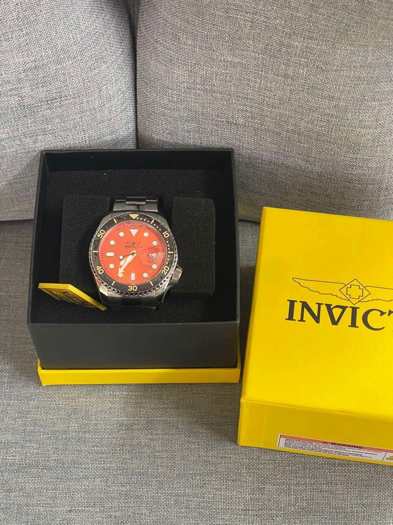 Invicta Pro Diver Orange Dial Watch with Box (Category: Men's Watches) located in Caloocan City. Submitted by Roowchelly (Listing ID 1470932966, Image 1). Description: - Brand: Invicta Dive Watch - Dial: Bright orange with a contrasting black bezel - Case & Bracelet: Stainless steel - Features: Date window at 3 o'clock with magnifier - Inclusions: Original bright yellow Invicta presentation box - Condition: Classic sporty design, ideal for everyd