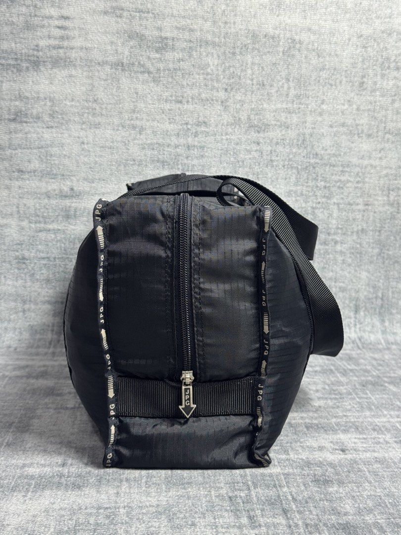 Jean Paul Gaultier - Weekender Nylon Bag (Category: Briefcases) located in Manila. Submitted by members-only (Listing ID 1471076628, Image 3). Description: JPG Nylon Duffle Bag In good condition No major issue Flaws: Faded JPG print in front Check pics for details JPG arrow zipper No holes.