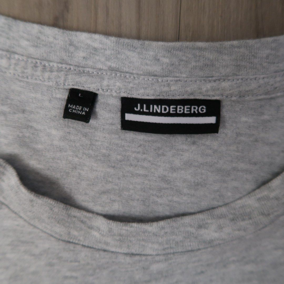 j.lindeberg Grey T-Shirt Size L (Category: Tshirts & Polo Shirts ) located in Manila. Submitted by mixi_lexi (Listing ID 1471034785, Image 2). Description: - Brand: J.Lindeberg - Color: Grey - Size: Large - Design: Classic crew neck with white logo printed on the chest - Origin: Made in China (per material tag) - Condition: Clean fabric, excellent ready-to-wear condition.
