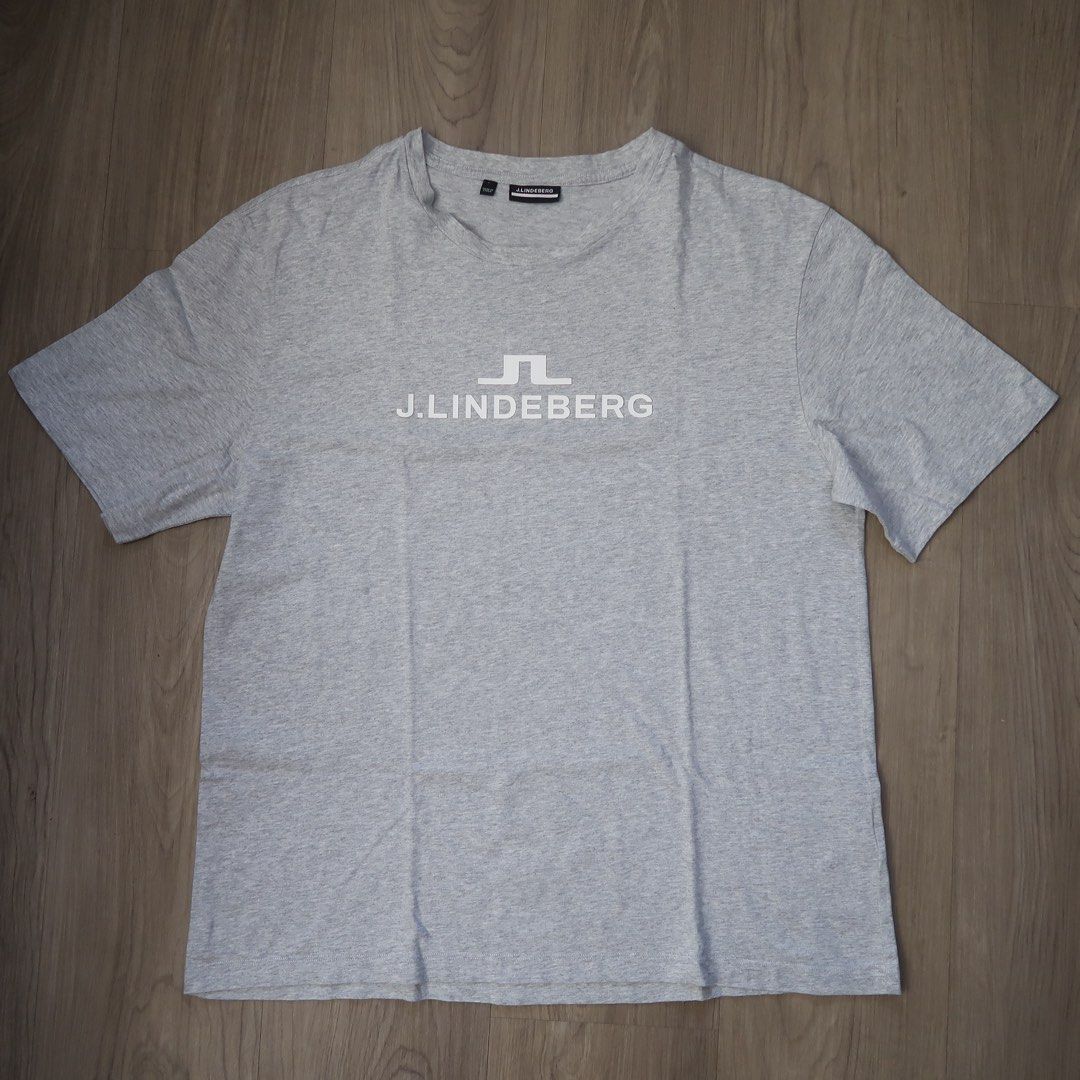 j.lindeberg Grey T-Shirt Size L (Category: Tshirts & Polo Shirts ) located in Manila. Submitted by mixi_lexi (Listing ID 1471034785, Image 1). Description: - Brand: J.Lindeberg - Color: Grey - Size: Large - Design: Classic crew neck with white logo printed on the chest - Origin: Made in China (per material tag) - Condition: Clean fabric, excellent ready-to-wear condition.