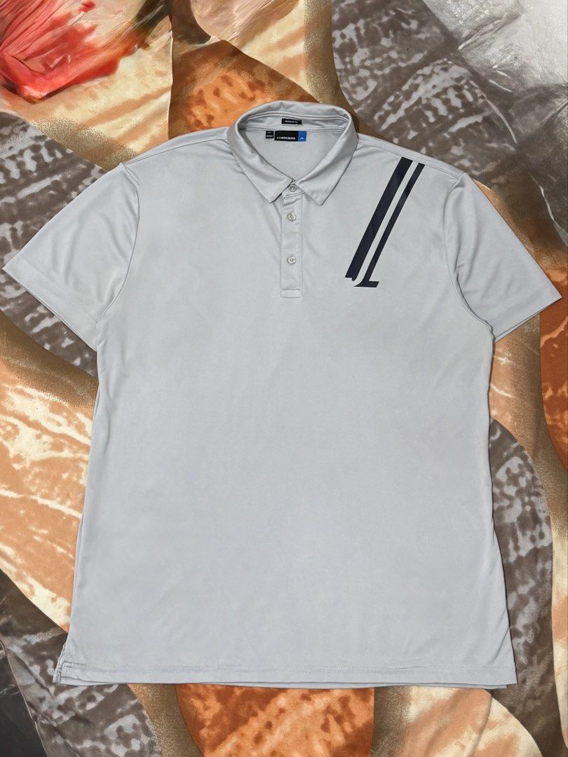 j.lindeberg Phoenix Reg Fit TX Coolmax Golf Polo (Category: Tshirts & Polo Shirts ) located in Manila. Submitted by calvinomateo14 (Listing ID 1471002567, Image 1). Description: - Brand: J.Lindeberg - Model: Phoenix Regular Fit Polo Shirt - Color: Light Grey - Size: XXL - Material: TX Coolmax fabric (100% polyester) for moisture-wicking and comfort - Design: Short sleeves, 3-button placket, diagonal stripe with JL logo on front - Details: Extra J