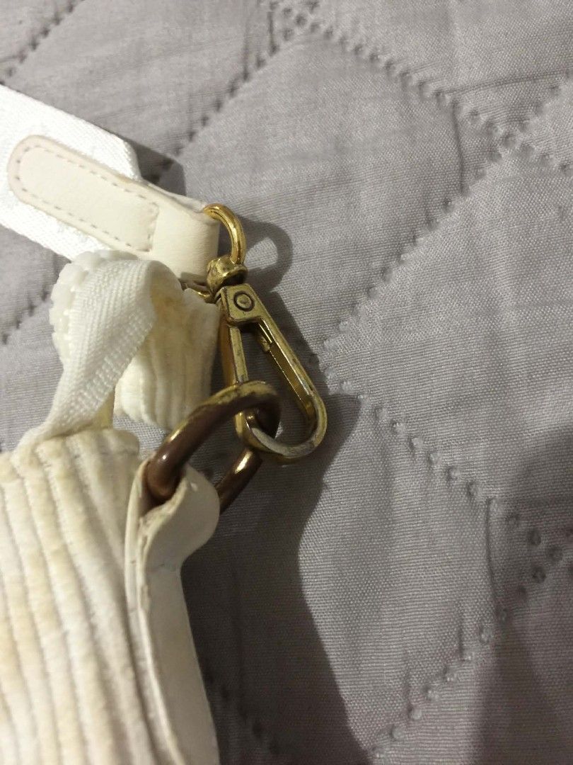 Jordan White Corduroy Shoulder Bag (Category: Shoulder Bags) located in Muntinlupa City. Submitted by prelovedbyanney (Listing ID 1471090441, Image 3). Description: FLAWS ARE SHOWN IN THE PHOTOS HAS YELLOWING ALREADY YELLOWING ISSUE ONLY - Color & Material: White corduroy with a soft ribbed texture - Branding: Iconic gold Jumpman logo on the front and woven Jordan lettering on the strap - Strap: Matching adjustable white strap with lobster clasps