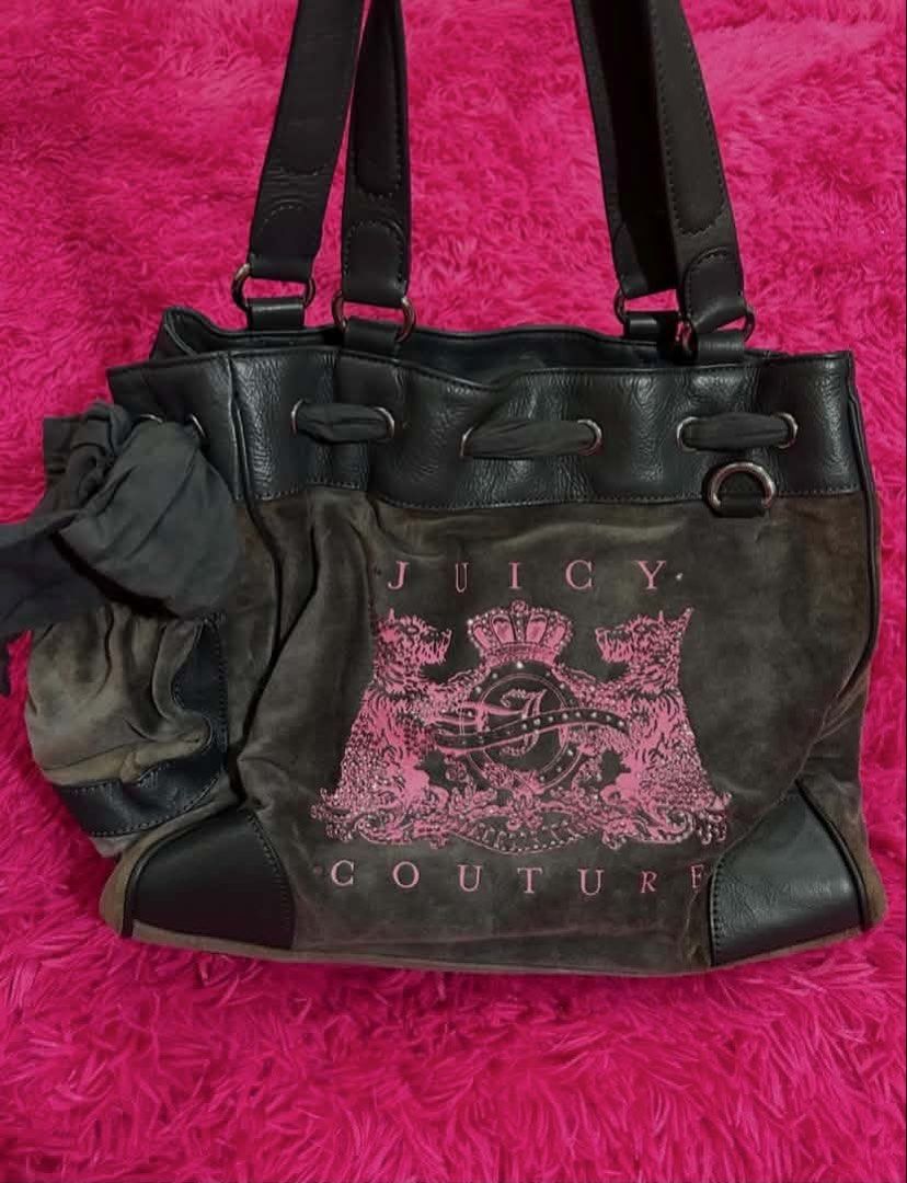 Juicy Couture Brown Suede Tote Handbag (Category: Tote Bags) located in Carmen. Submitted by juicy_gal (Listing ID 1471069642, Image 2). Description: - Brand: Juicy Couture - Material: Brown suede with dark leather trim - Design: Large pink crest graphic on front & heart-shaped 'J' patch on the back - Closure: Drawstring top - Features: Dual shoulder straps, cute side fabric bow detail, and roomy interior - Style: Retro Y2K daily tote.