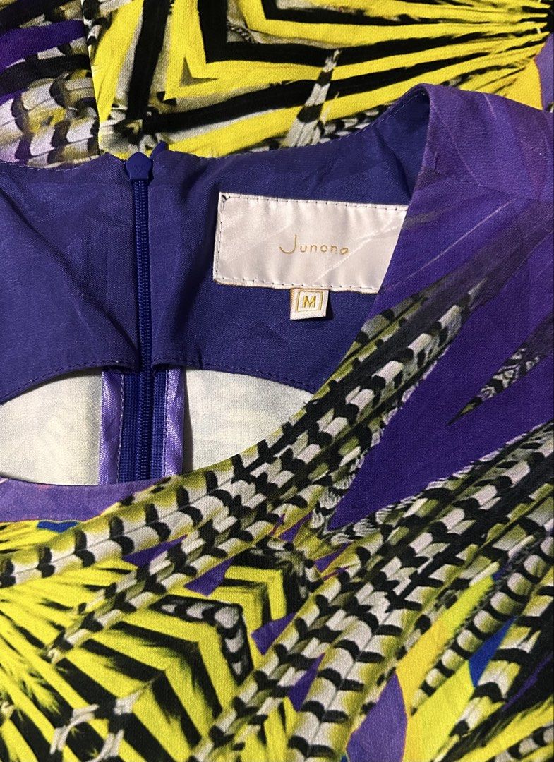 JUNONA (Category: Dresses) located in Davao. Submitted by sart0ria85 (Listing ID 1470963595, Image 3). Description: Sleeveless dress with round neckline and back zipper closure. Bold purple and yellow graphic print with geometric and feather patterns. 55%COTTON 42%POLYESTER 3%ELASTANE MADE IN KOREA 🇰🇷 MEDIUM. Size 6 EXCELLENT CONDITION (98/100).