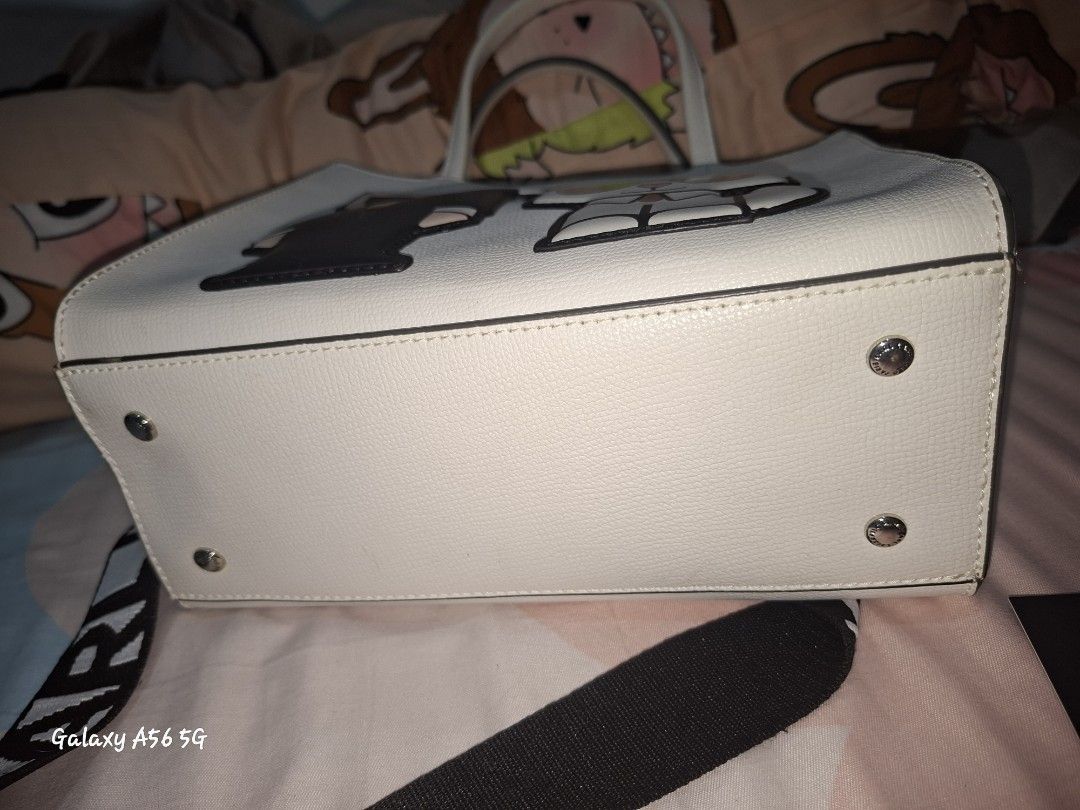 Karl Lagerfeld Paris Winter White Handbag (Category: Shoulder Bags) located in Cavite. Submitted by lvjohnsen (Listing ID 1471055859, Image 2). Description: - Brand: Karl Lagerfeld Paris - Color: Winter White - Condition: Brand new with original tags attached (MSRP $198) - Design: Cute Karl and Choupette graphic appliques on the front - Structure: Structured shape with double top handles and protective metal feet on the bottom - Interior: Feature