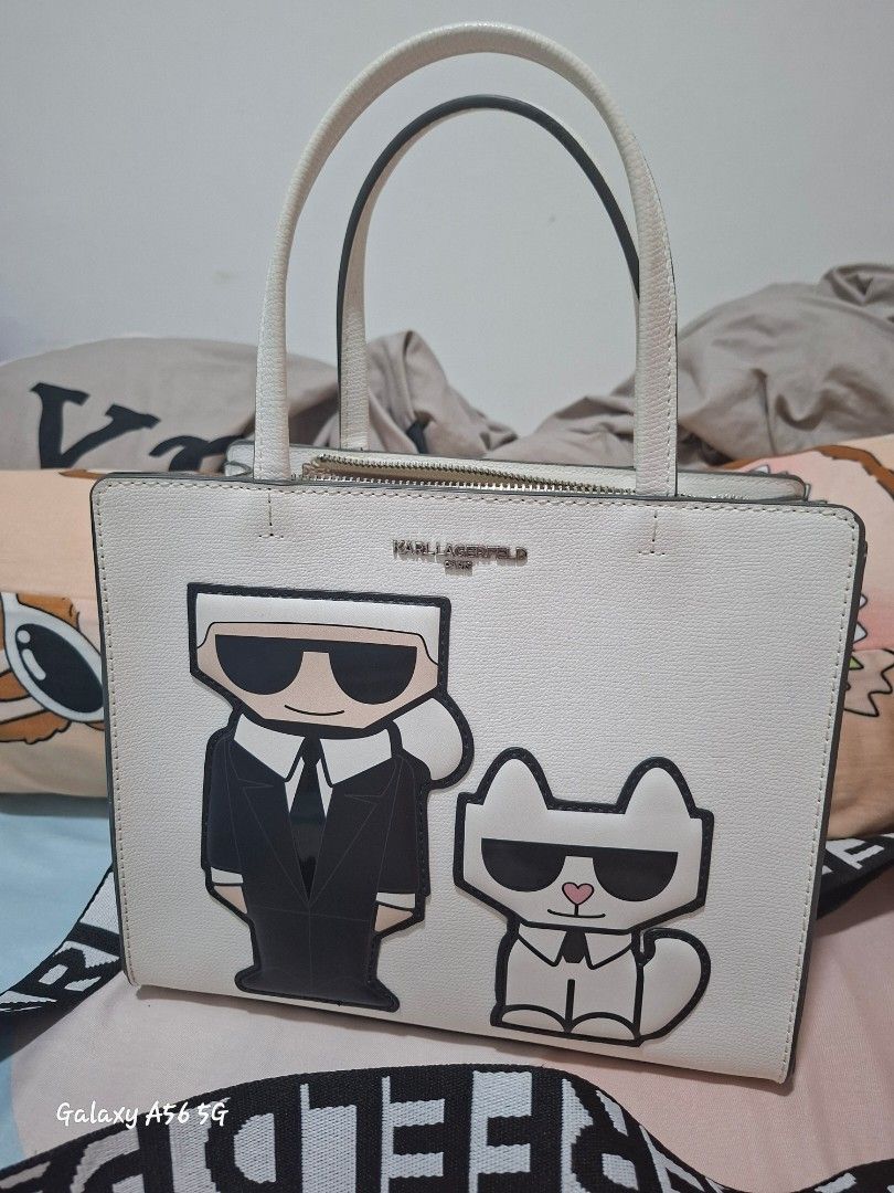 Karl Lagerfeld Paris Winter White Handbag (Category: Shoulder Bags) located in Cavite. Submitted by lvjohnsen (Listing ID 1471055859, Image 1). Description: - Brand: Karl Lagerfeld Paris - Color: Winter White - Condition: Brand new with original tags attached (MSRP $198) - Design: Cute Karl and Choupette graphic appliques on the front - Structure: Structured shape with double top handles and protective metal feet on the bottom - Interior: Feature