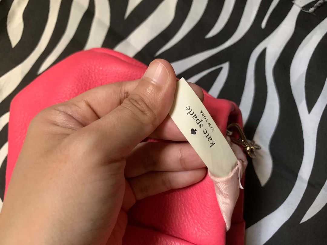 Kate Spade Crossbody Bag (Category: Cross-body Bags) located in Manila. Submitted by usagichan_rabbit (Listing ID 1471015533, Image 3). Description: - Brand: Kate Spade New York - Style: Leather crossbody bag - Color: Bright pink with gold-tone hardware - Strap: Elegant gold chain strap - Interior: Signature logo print pink fabric lining - Closure: Zip closure with matching leather pull tabs and metal end caps - Condition: Minor scuffs and scratc