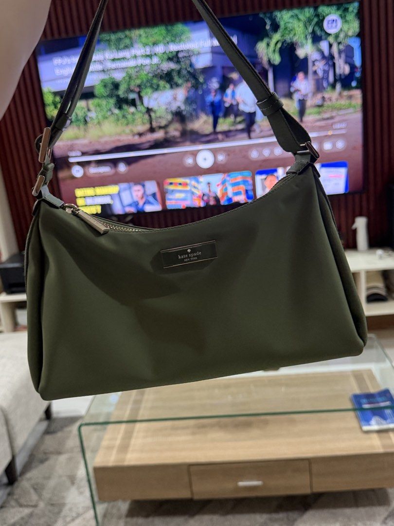 Kate Spade Green Nylon Shoulder Bag (Category: Luxury Bags & Wallets) located in Manila. Submitted by wildstorm.986cf1 (Listing ID 1470971593, Image 1). Description: - Brand: Kate Spade New York - Color: Olive Green - Material: Durable and lightweight nylon - Closure: Secure top zipper - Details: Front metal logo plaque - Strap: Matching green strap with side adjustable buckles - Condition: Clean, practical, and ideal for daily use.
