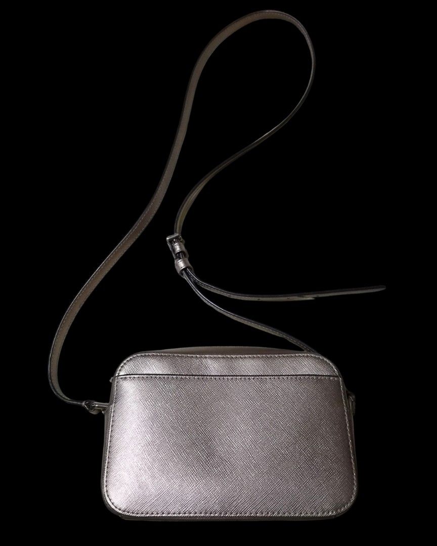 Kate Spade Metallic Saffiano Leather Mini Camera Bag | Adjustable Strap (Pre-Owned) (Category: Cross-body Bags) located in Manila. Submitted by cinnamon5 (Listing ID 1471063745, Image 2). Description: Authentic Kate Spade New York Metallic Saffiano Leather Camera Crossbody Bag Elevate any outfit with this chic Kate Spade metallic camera bag! Crafted from durable Saffiano leather with an eye-catching champagne-silver metallic finish, this compact 