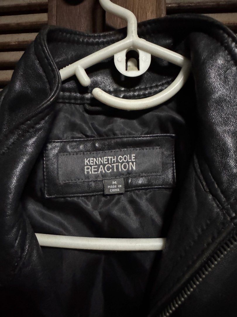 Kenneth Cole Reaction Black Leather Jacket Size M (Category: Coats, Jackets and Outerwear) located in Angono. Submitted by gie_vicente (Listing ID 1470987507, Image 2). Description: - Brand: Kenneth Cole Reaction - Color: Black - Material: Leather - Size: Medium (M) - Closure: Full zip front - Pockets: Multiple front flap pockets - Details: Waist strap with snap buttons, classic biker-style silhouette - Origin: Made in China - Condition: Solid co