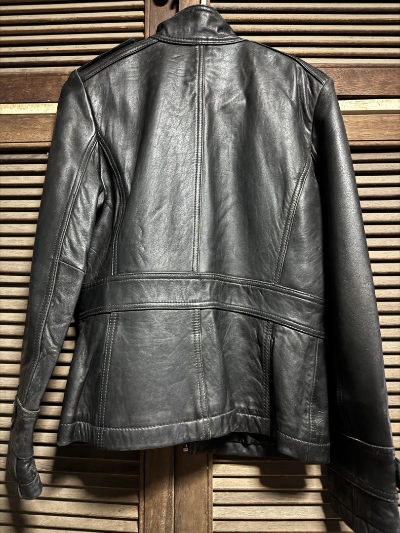 Kenneth Cole Reaction Black Leather Jacket Size M (Category: Coats, Jackets and Outerwear) located in Angono. Submitted by gie_vicente (Listing ID 1470987507, Image 3). Description: - Brand: Kenneth Cole Reaction - Color: Black - Material: Leather - Size: Medium (M) - Closure: Full zip front - Pockets: Multiple front flap pockets - Details: Waist strap with snap buttons, classic biker-style silhouette - Origin: Made in China - Condition: Solid co