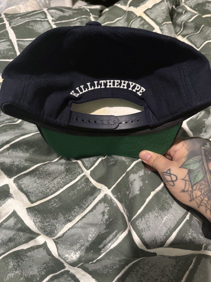 Kill The Hype Los Angeles Lakers Snapback Hat (Category: Caps & Hats) located in Manila. Submitted by safeowl.b6dbb0 (Listing ID 1471023772, Image 2). Description: - Brand: Kill The Hype (KTH) - Style: Los Angeles Lakers Snapback Cap - Color: Navy blue with green undervisor - Front Design: Upside-down Lakers embroidery in yellow and purple - Side Detail: Yellow KTH logo embroidery - Back Detail: White Kill The Hype embroidery above the adjustable