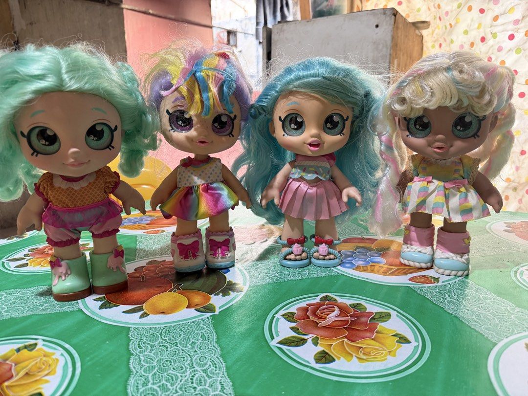 Kindi Kids Dolls Bundle with Accessories (Category: Kids Toys) located in Quezon City. Submitted by patricafort (Listing ID 1471023087, Image 1). Description: - Set of 4 Kindi Kids dolls with pastel hair (mint green, rainbow, blue, and blonde) - Each doll comes in a vibrant dress with matching shoes - Includes 5 adorable food-themed accessories: bubble tea cup, cupcake container, jar of sprinkles, smoothie cup, plus a brush - Ideal for kids' play