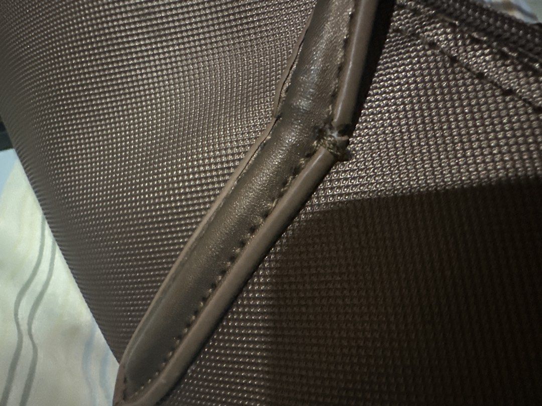 Lacoste Brown Tote Bag (Category: Tote Bags) located in Talisay. Submitted by kuyav (Listing ID 1471036583, Image 2). Description: - Brand: Lacoste - Color: Classic Brown - Features: Double shoulder straps, secure zip-top closure, structured canvas-like texture - Design: Iconic green crocodile logo on the front - Perfect for: Daily commuting, running errands, and everyday casual outfits -Issue:Leather strap has a tear, uses keychain for the zippe