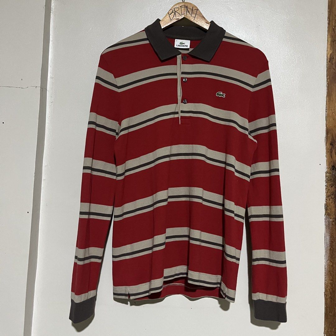 Lacoste Devanlay Long Sleeve Striped Polo Shirt (Category: Tshirts & Polo Shirts ) located in Argao. Submitted by secondcyclecollection (Listing ID 1471068963, Image 2). Description: - Brand: Lacoste - Size : Medium To Large - Style: Long sleeve polo shirt with horizontal stripes (red, beige, dark brown) - Details: Dark brown collar, sleeve cuffs, and three-button placket with dark buttons - Branding: Iconic embroidered crocodile logo on the left