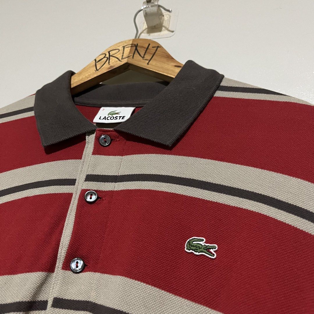 Lacoste Devanlay Long Sleeve Striped Polo Shirt (Category: Tshirts & Polo Shirts ) located in Argao. Submitted by secondcyclecollection (Listing ID 1471068963, Image 1). Description: - Brand: Lacoste - Size : Medium To Large - Style: Long sleeve polo shirt with horizontal stripes (red, beige, dark brown) - Details: Dark brown collar, sleeve cuffs, and three-button placket with dark buttons - Branding: Iconic embroidered crocodile logo on the left