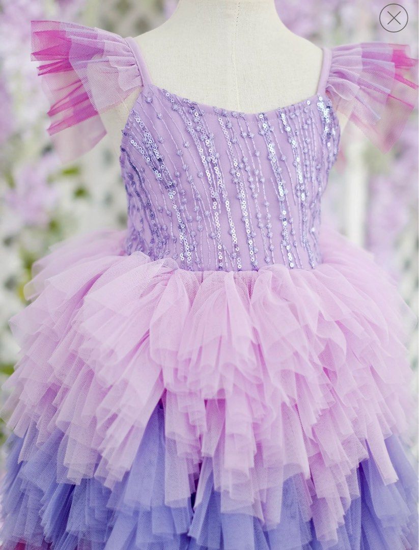 Laila and Lyra Laurette Size 4 (Category: Babies & Kids Fashion) located in Daraga. Submitted by iamsupershein (Listing ID 1470938752, Image 2). Description: - Stunning ombre tulle dress with lavender, lilac, and vibrant magenta tiers - Sleeves feature cute ruffled tulle detailing - Bodice is fully covered in shimmering vertical sequin stripes and beading - Designed with a classic scoop neckline and structured fit - Ideal statement piece for birt