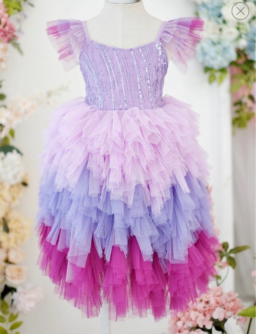 Laila and Lyra Laurette Size 4 (Category: Babies & Kids Fashion) located in Daraga. Submitted by iamsupershein (Listing ID 1470938752, Image 3). Description: - Stunning ombre tulle dress with lavender, lilac, and vibrant magenta tiers - Sleeves feature cute ruffled tulle detailing - Bodice is fully covered in shimmering vertical sequin stripes and beading - Designed with a classic scoop neckline and structured fit - Ideal statement piece for birt