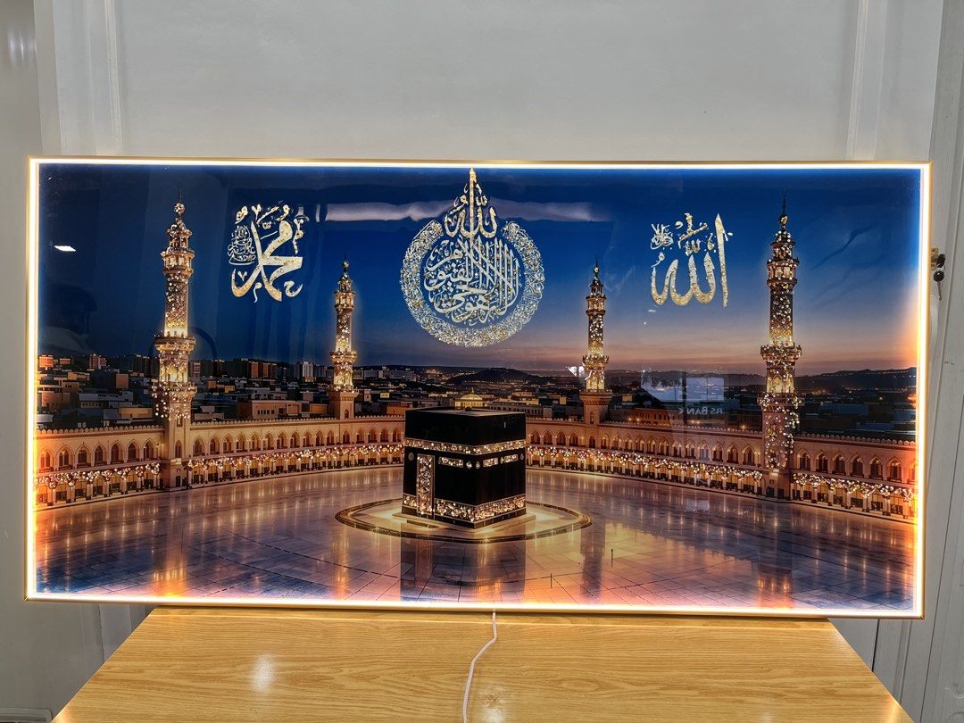 LED Lighted Kaaba Islamic Wall Art Calligraphy (Category: Wall Decor) located in Tagaytay City. Submitted by mommaowl888 (Listing ID 1471065579, Image 3). Description: - Design: Kaaba in Mecca with Arabic calligraphy (Allah, Muhammad, Quranic verses) - Details: Gold and silver glitter accents on a blue sky background - Lighting: Built-in LED backlighting around the gold frame - Power: USB cable included - Material: Heavy glass or acrylic front - 