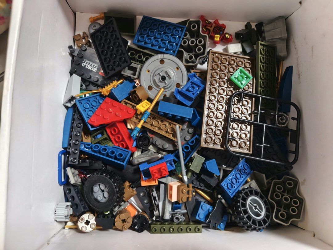 LEGO Minifigures and Mixed Bricks Box Set (Category: Lego & Building Sets) located in Manila. Submitted by decluttersmpaloc (Listing ID 1470966795, Image 2). Description: - Assorted LEGO minifigures including Batman, Iron Man, Thor, and Ninjago characters - Includes various accessories such as weapons and shields - Comes with a full box of mixed loose bricks, plates, and wheels in multiple colors - Great collection for creative building and playt