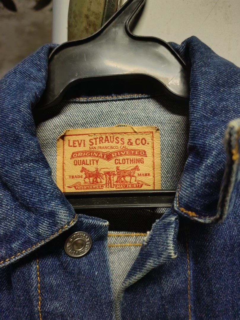 Levi Strauss & Co. Denim Jacket Size S (Category: Coats, Jackets and Outerwear) located in Manila. Submitted by katrina.who (Listing ID 1471024361, Image 2). Description: - Brand: Levi's - Style: Classic denim jacket (Model 57511) - Wash: Dark blue with striking orange contrast stitching - Size: Small - Closures: Metal button front - Pockets: Two button-flap chest pockets and convenient vertical side pockets - Details: Features traditional tan le