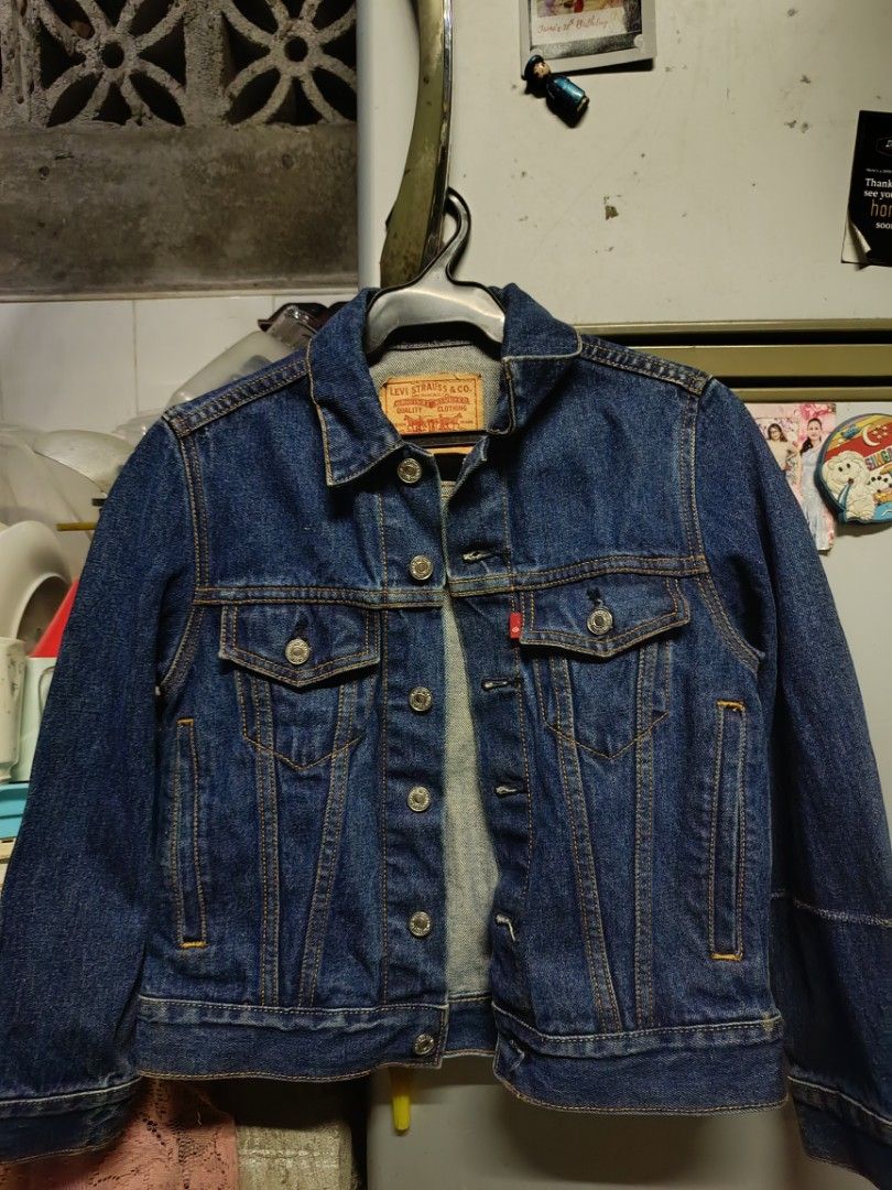 Levi Strauss & Co. Denim Jacket Size S (Category: Coats, Jackets and Outerwear) located in Manila. Submitted by katrina.who (Listing ID 1471024361, Image 1). Description: - Brand: Levi's - Style: Classic denim jacket (Model 57511) - Wash: Dark blue with striking orange contrast stitching - Size: Small - Closures: Metal button front - Pockets: Two button-flap chest pockets and convenient vertical side pockets - Details: Features traditional tan le