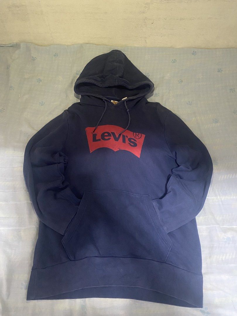 Levi's Navy Blue Hoodie Size S (Category: Coats, Jackets and Outerwear) located in Manila. Submitted by cj_thrift10 (Listing ID 1471051501, Image 1). Description: - Brand: Levi's - Color: Navy Blue with classic red front logo graphic - Size: Small (Tag shows 165/84A) - Material: Soft cotton blend, ideal for cooler weather - Features: Drawstring hood and front kangaroo pocket - Condition: Brand new with tag attached.