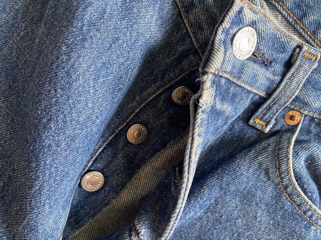 Levi's Straight Leg Denim Jeans Blue (Category: Jeans) located in Quezon City. Submitted by damclothings.ph (Listing ID 1470954283, Image 2). Description: - Brand: Levi's - Wash: Mid-wash blue with natural fading - Fit: Classic straight leg - Closure: Button fly - Details: Tan leather patch at back waistband, standard rear pockets - Material: Durable cotton fabric - Condition/Vibe: alter on the other leg.
