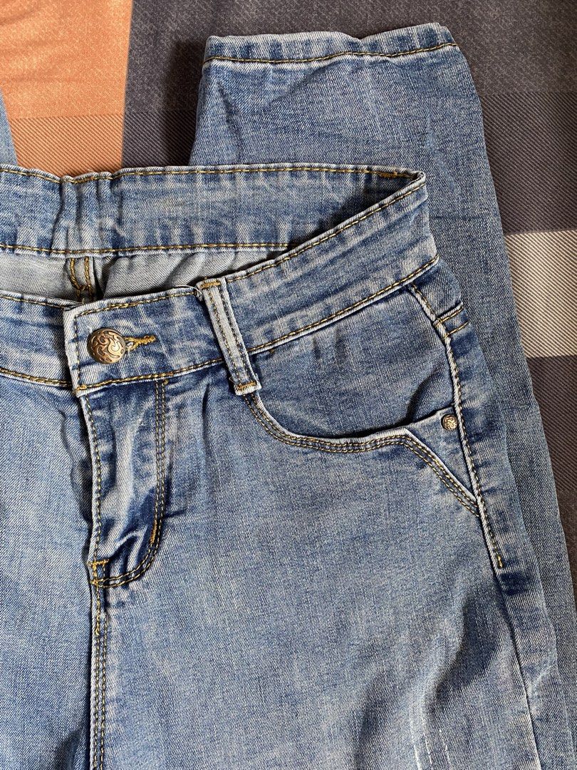 Light Blue Denim Jeans Bundle (2 Pairs) (Category: Jeans) located in Manila. Submitted by heyheyruok (Listing ID 1470953753, Image 3). Description: - Bundle includes 2 pairs of light blue mid-rise denim jeans - Both feature a secure front button closure for daily wear - Pair 1: Features unique large stitched pockets on the back - Pair 2: Classic pockets with subtle fading and distressing details - Versatile, casual staples ready for your weekly r