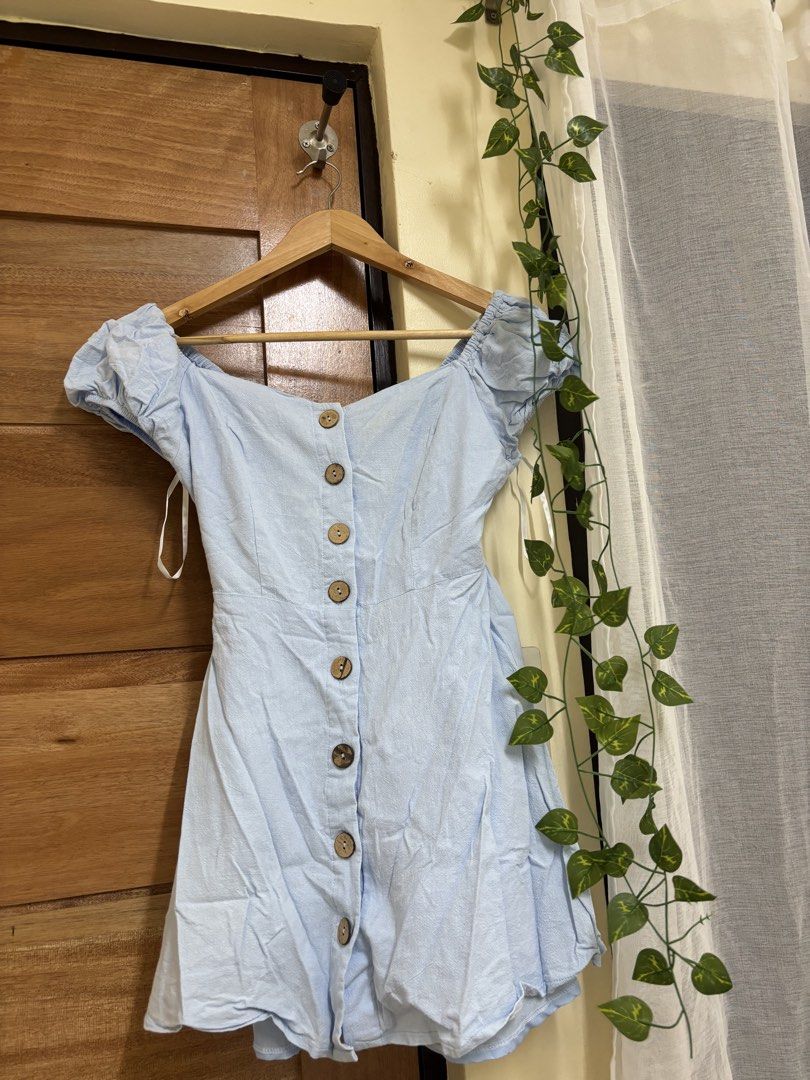 Light Blue Puff Sleeve Button-Down Mini Dress (Category: Dresses) located in Manila. Submitted by vegajhassel (Listing ID 1471039776, Image 1). Description: - Color: Light blue - Design: Short puff sleeves, sweetheart neckline, and front wooden buttons - Fit: Fitted waist with a slight flare at the skirt - Condition: Worn once for a Tagaytay trip, excellent shape, clean and ready to wear - Perfect for casual outings, dates, or weekend getaways.